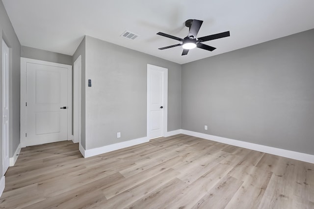 unfurnished bedroom with baseboards, visible vents, ceiling fan, and light wood-type flooring