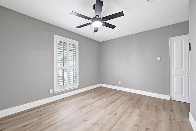 empty room featuring baseboards, a ceiling fan, and wood finished floors