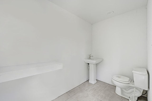 bathroom featuring tile patterned floors and toilet