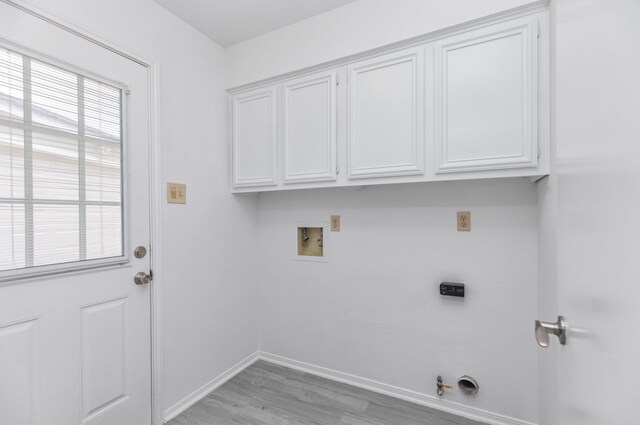 washroom featuring hookup for a gas dryer, baseboards, cabinet space, washer hookup, and hookup for an electric dryer