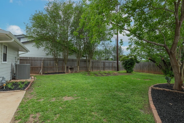 view of yard with a fenced backyard and central air condition unit