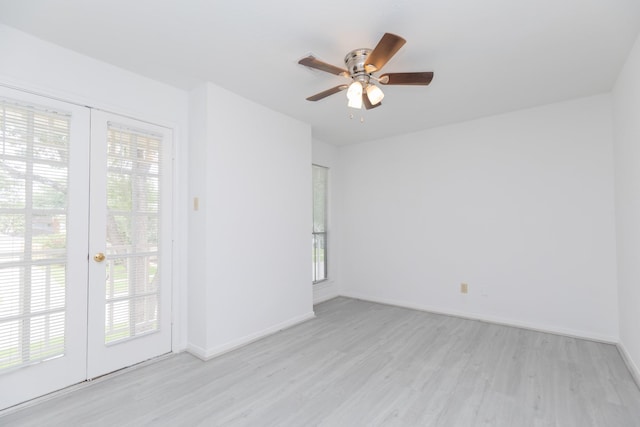 unfurnished room featuring baseboards, ceiling fan, and light wood-style floors
