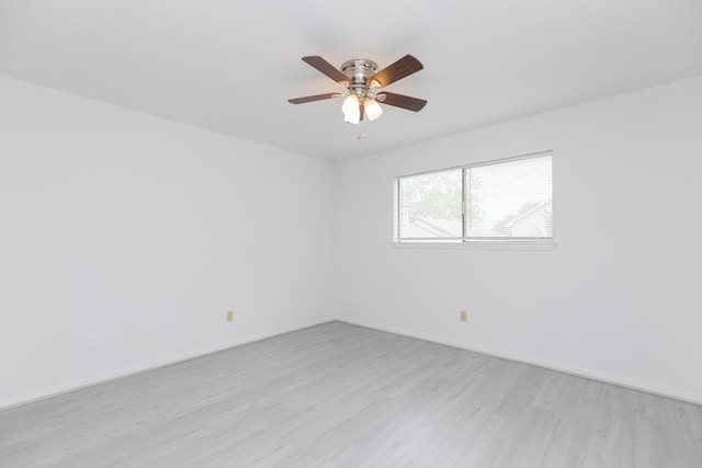 unfurnished room featuring baseboards, a ceiling fan, and light wood finished floors