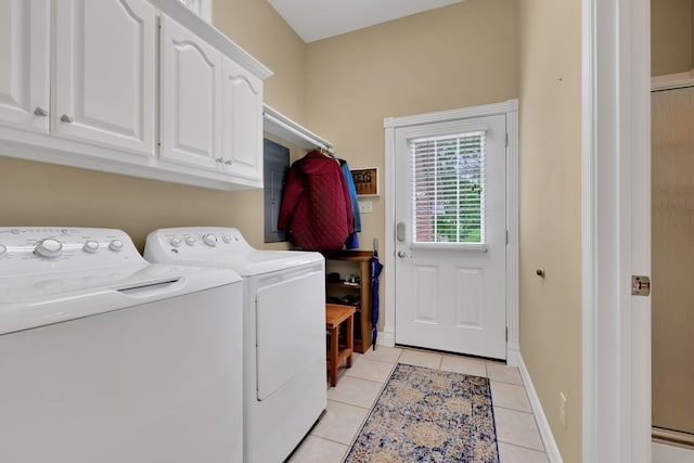 laundry room with baseboards, washer and clothes dryer, cabinet space, and light tile patterned floors