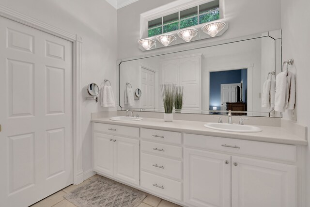 bathroom with a sink, tile patterned floors, and double vanity