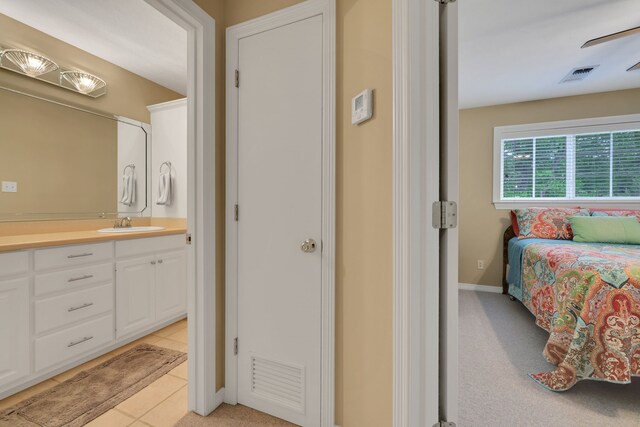 bathroom with visible vents, baseboards, tile patterned flooring, and vanity