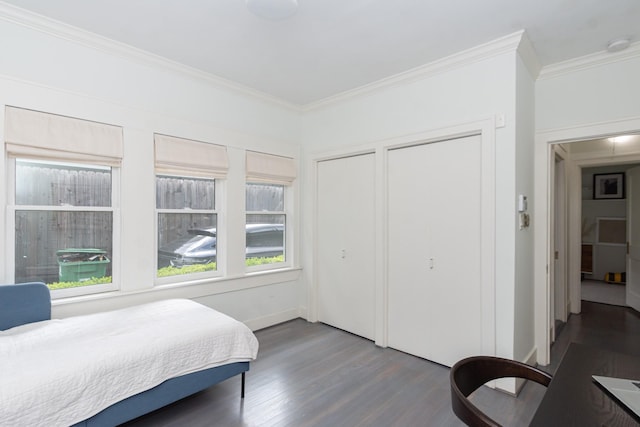 bedroom with crown molding and dark wood-style floors