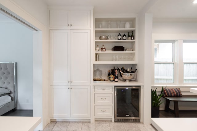 bar with beverage cooler, a dry bar, and tasteful backsplash