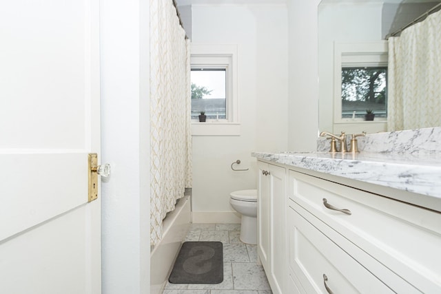 bathroom with vanity, baseboards, and toilet