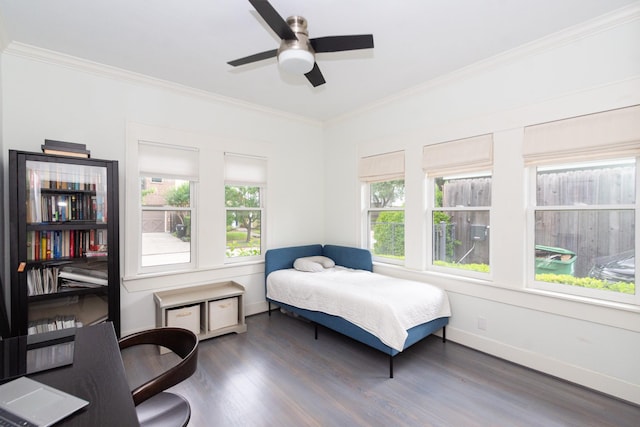 bedroom featuring baseboards, ornamental molding, ceiling fan, and wood finished floors