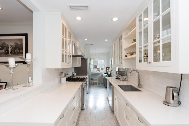 kitchen with appliances with stainless steel finishes, a sink, recessed lighting, tasteful backsplash, and visible vents