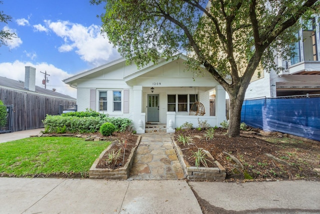 bungalow with brick siding and fence
