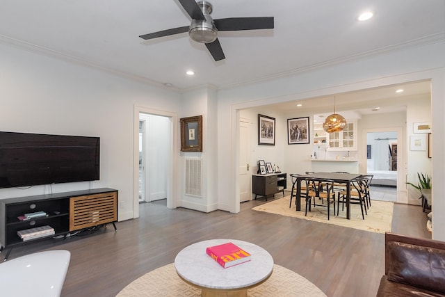 living area with a ceiling fan, recessed lighting, and wood finished floors