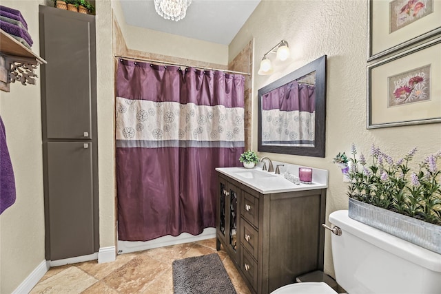 full bathroom featuring vanity, a textured wall, toilet, and curtained shower