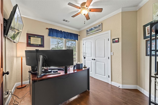 home office featuring visible vents, crown molding, a textured wall, wood finished floors, and a ceiling fan