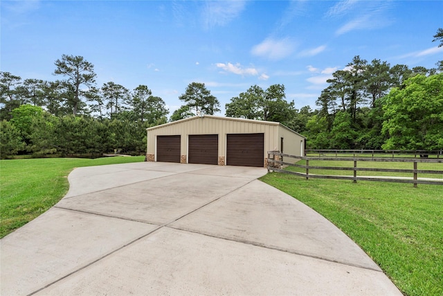 detached garage featuring fence