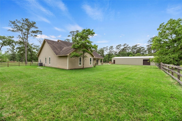 view of yard featuring fence and an outbuilding