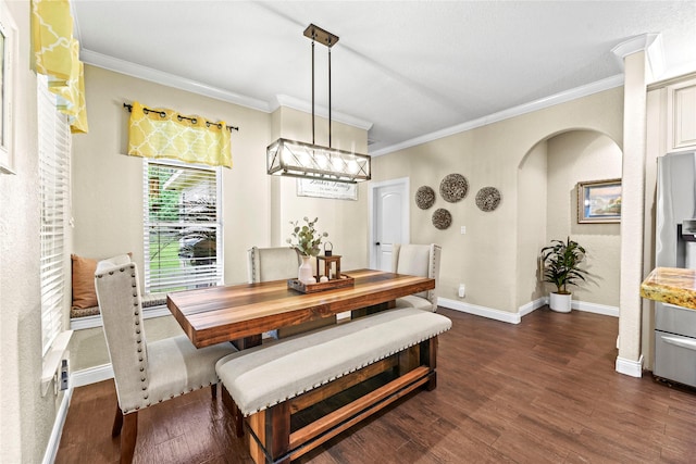 dining space with baseboards, ornamental molding, arched walkways, and dark wood-style floors
