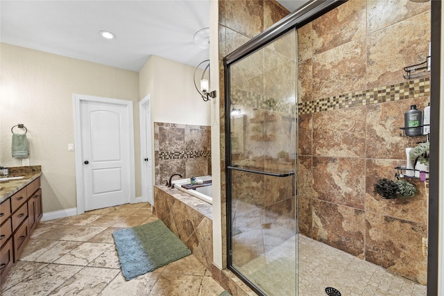 full bathroom with vanity, recessed lighting, baseboards, a shower stall, and a bath