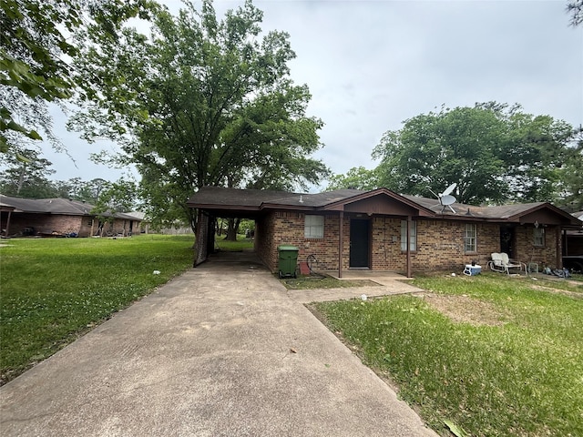 ranch-style home with brick siding, a front lawn, an attached carport, and concrete driveway