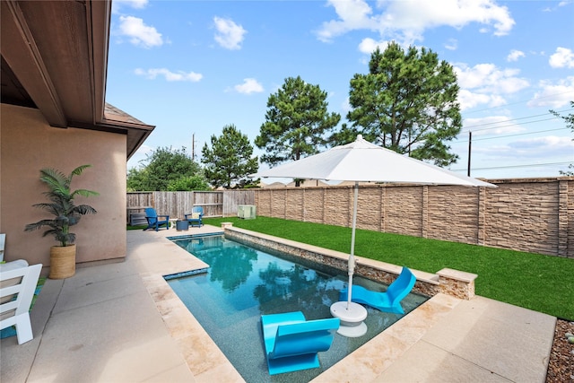 view of pool featuring a lawn, a fenced in pool, a fenced backyard, and a patio area