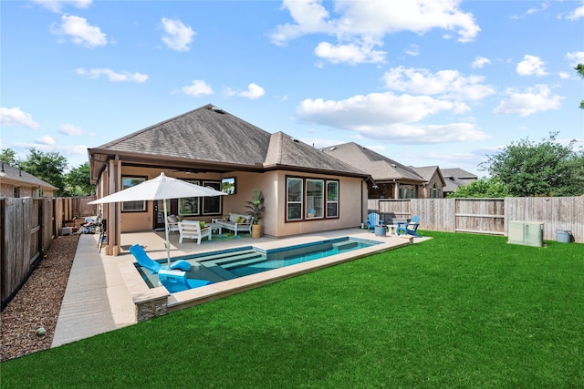 back of property with a fenced backyard, an outdoor hangout area, a shingled roof, a patio area, and a yard