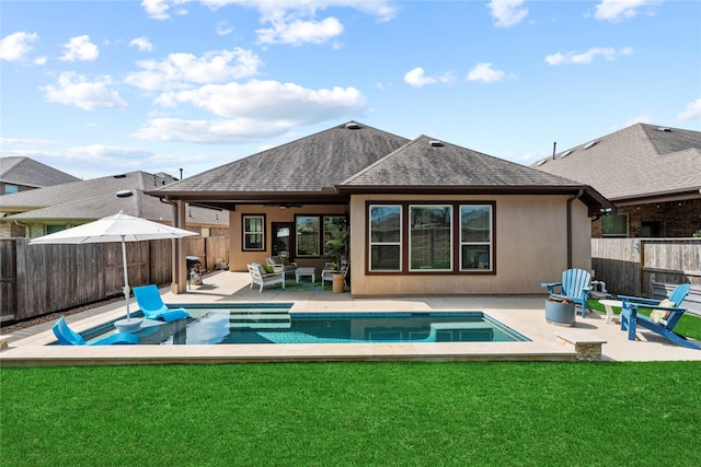 back of property featuring a yard, a fenced backyard, and a patio area