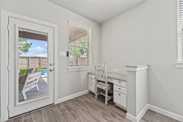 office area with baseboards, a healthy amount of sunlight, and light wood-type flooring