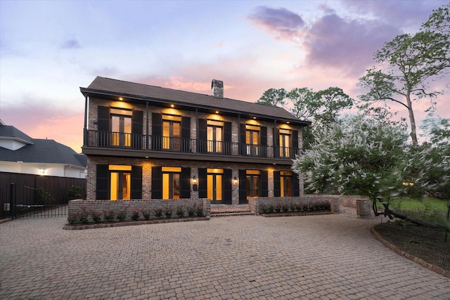 5040 Fieldwood Dr, Houston, TX 77056 - rear view of property featuring french doors, a chimney, fence, a balcony, and brick siding