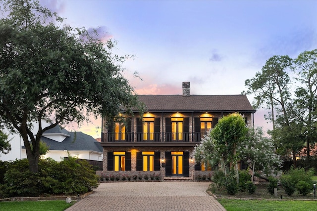 5040 Fieldwood Dr, Houston, TX 77056 - view of front of property featuring brick siding, a chimney, decorative driveway, and a balcony