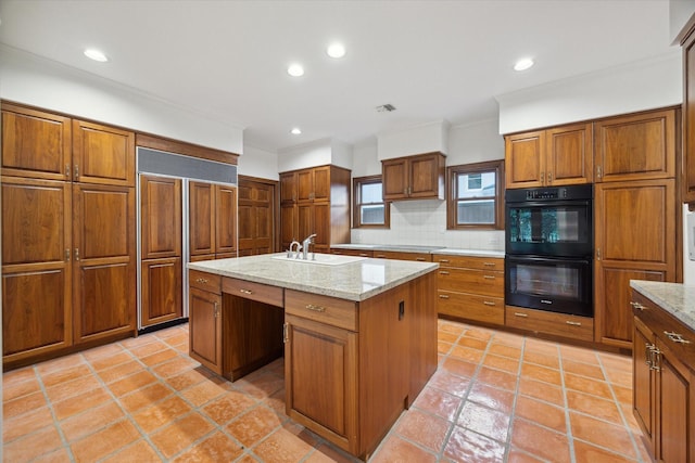 5040 Fieldwood Dr, Houston, TX 77056 - kitchen featuring a sink, a center island with sink, dobule oven black, backsplash, and paneled refrigerator