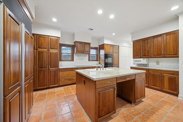 5040 Fieldwood Dr, Houston, TX 77056 - kitchen featuring a sink, brown cabinetry, paneled built in fridge, a kitchen island with sink, and backsplash
