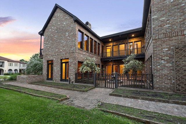 5040 Fieldwood Dr, Houston, TX 77056 - view of front of home with a patio, brick siding, and a balcony