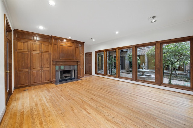 5040 Fieldwood Dr, Houston, TX 77056 - unfurnished living room featuring a fireplace, recessed lighting, visible vents, and light wood-style floors