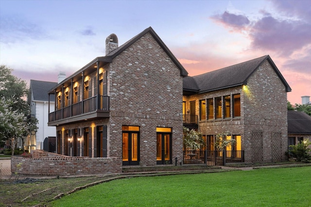 5040 Fieldwood Dr, Houston, TX 77056 - back of house featuring a balcony, a chimney, and brick siding