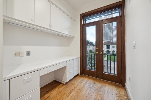 5040 Fieldwood Dr, Houston, TX 77056 - unfurnished office with built in desk, baseboards, french doors, and light wood finished floors