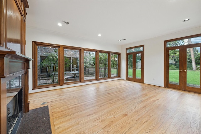 5040 Fieldwood Dr, Houston, TX 77056 - unfurnished living room featuring a high end fireplace, french doors, visible vents, and light wood-style flooring
