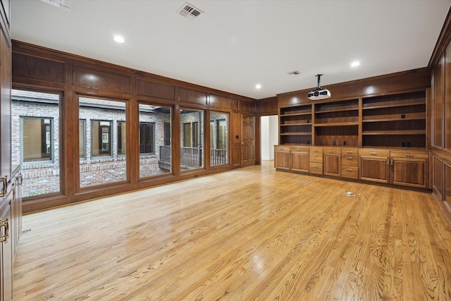 5040 Fieldwood Dr, Houston, TX 77056 - unfurnished living room with light wood-style floors, wooden walls, visible vents, and ornamental molding