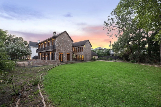 5040 Fieldwood Dr, Houston, TX 77056 - back of property featuring a chimney, fence, a lawn, a balcony, and brick siding