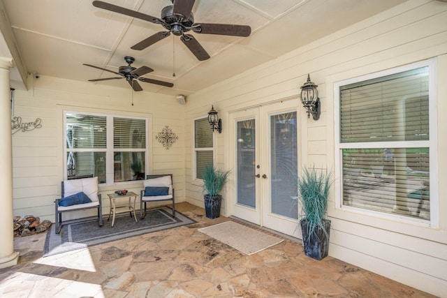 view of exterior entry with french doors, ceiling fan, and a patio area
