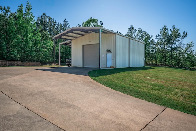 view of outdoor structure featuring concrete driveway and an outdoor structure