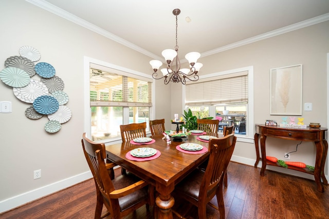 dining area with baseboards, ornamental molding, wood finished floors, and a chandelier