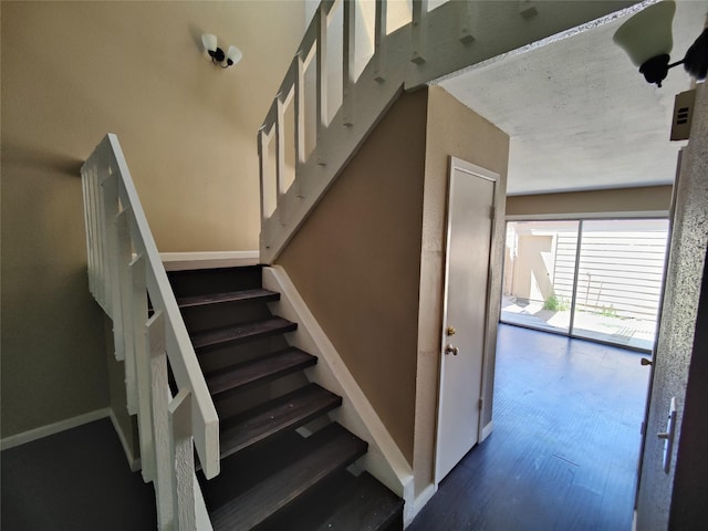 stairs with baseboards and wood finished floors