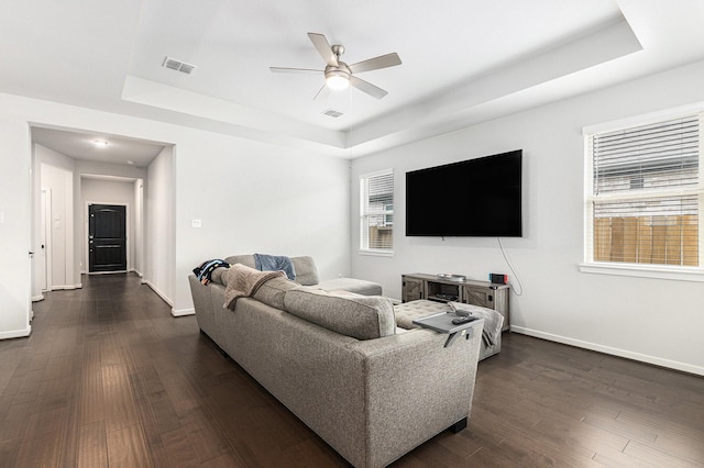 9118 Brixham Dr, Cypress, TX 77433 - living room featuring a tray ceiling, ceiling fan, and baseboards