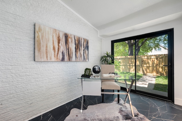 home office featuring lofted ceiling, brick wall, and marble finish floor
