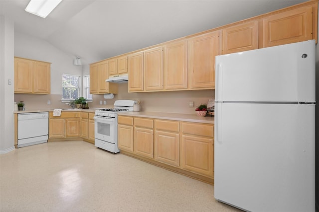 kitchen with white appliances, light brown cabinetry, vaulted ceiling, and light countertops