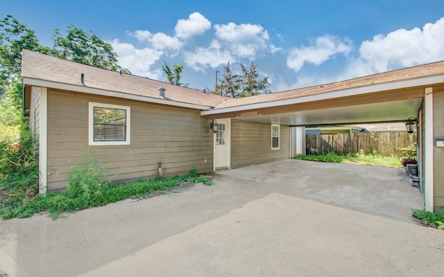 ranch-style house with fence and a carport