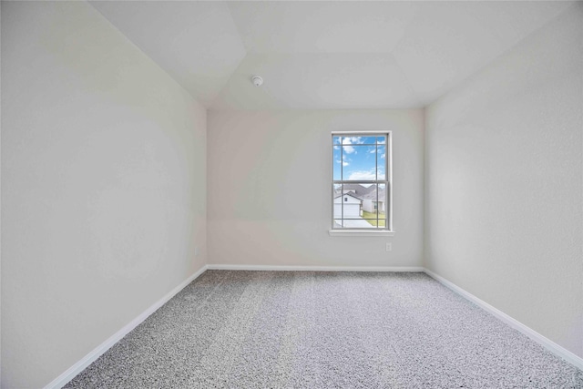 carpeted spare room with baseboards