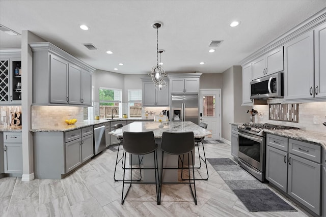 kitchen with gray cabinetry, appliances with stainless steel finishes, recessed lighting, and visible vents
