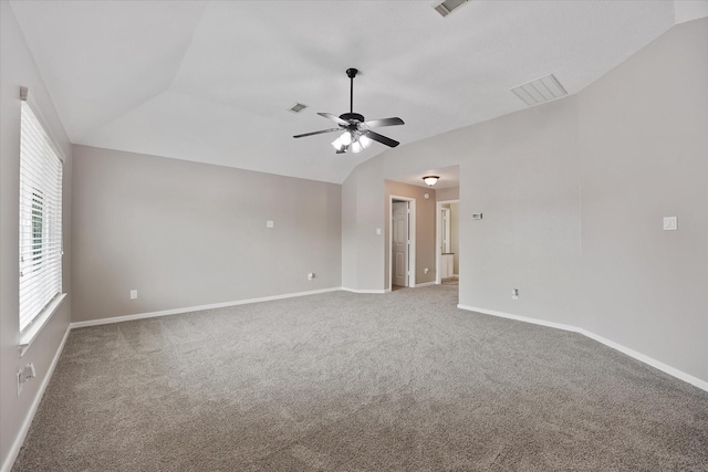 unfurnished room featuring carpet floors, visible vents, baseboards, ceiling fan, and vaulted ceiling